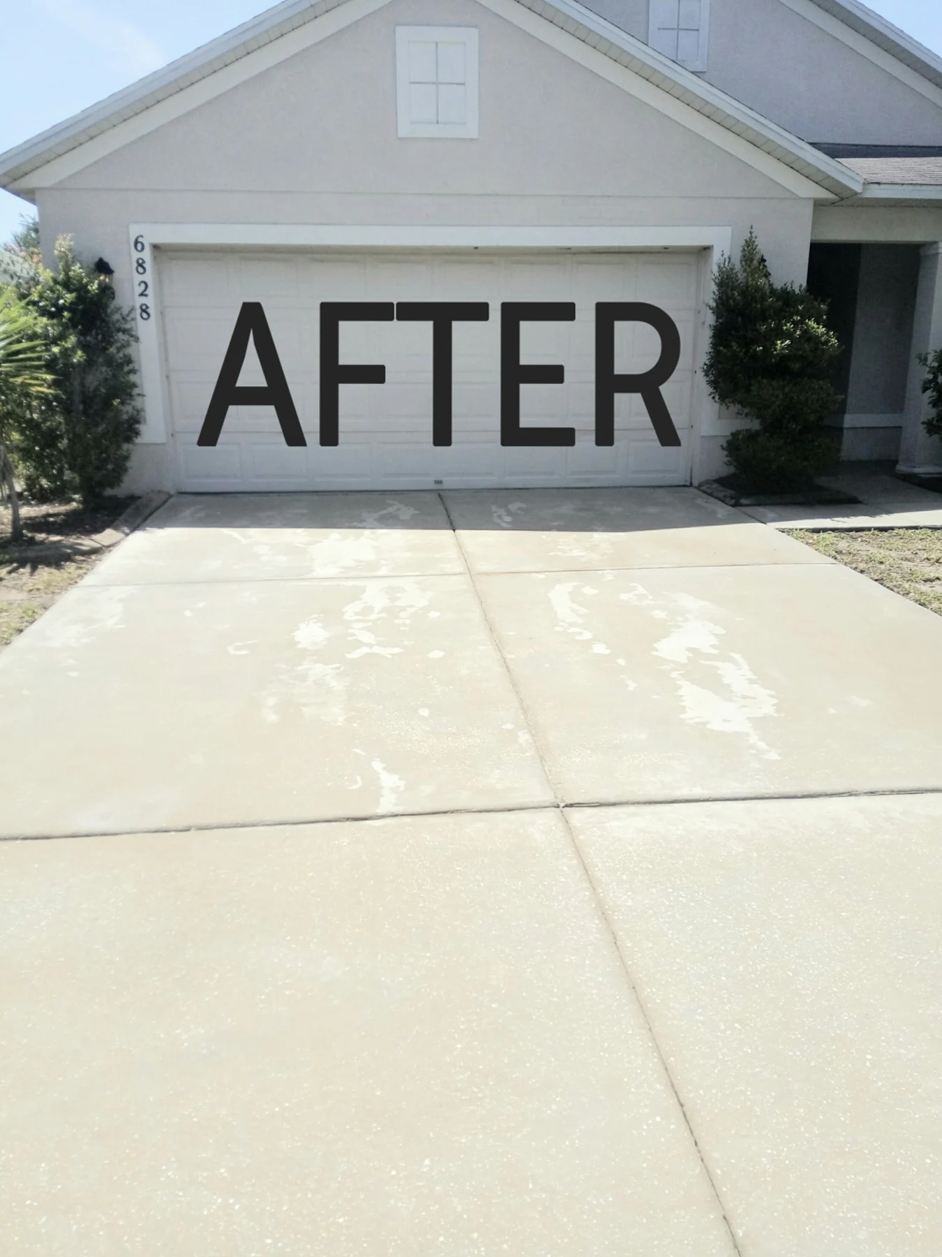 The driveway after pressure washing, with a brighter, cleaner concrete surface